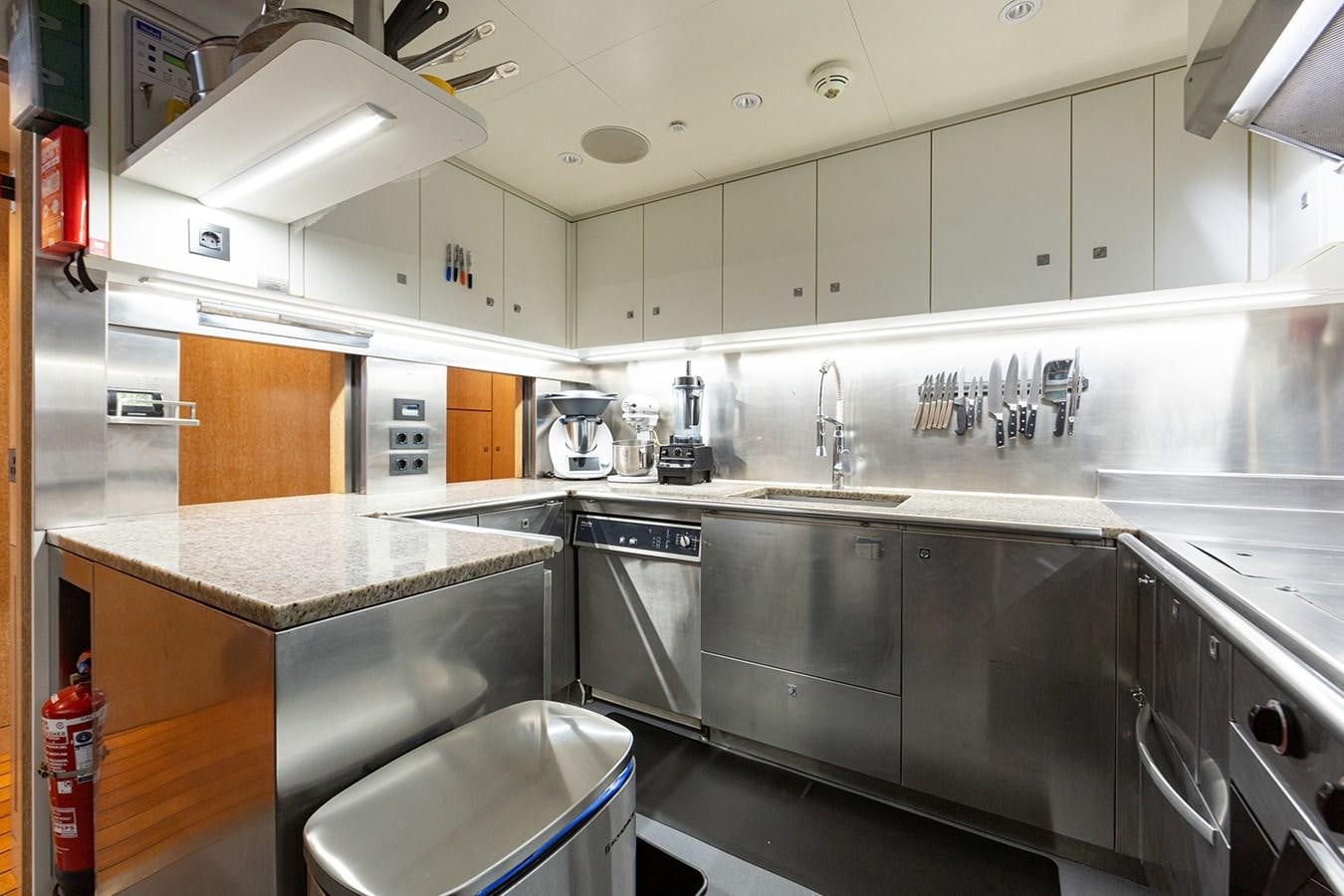 a kitchen with stainless steel appliances aboard BELONGERS Yacht for Sale