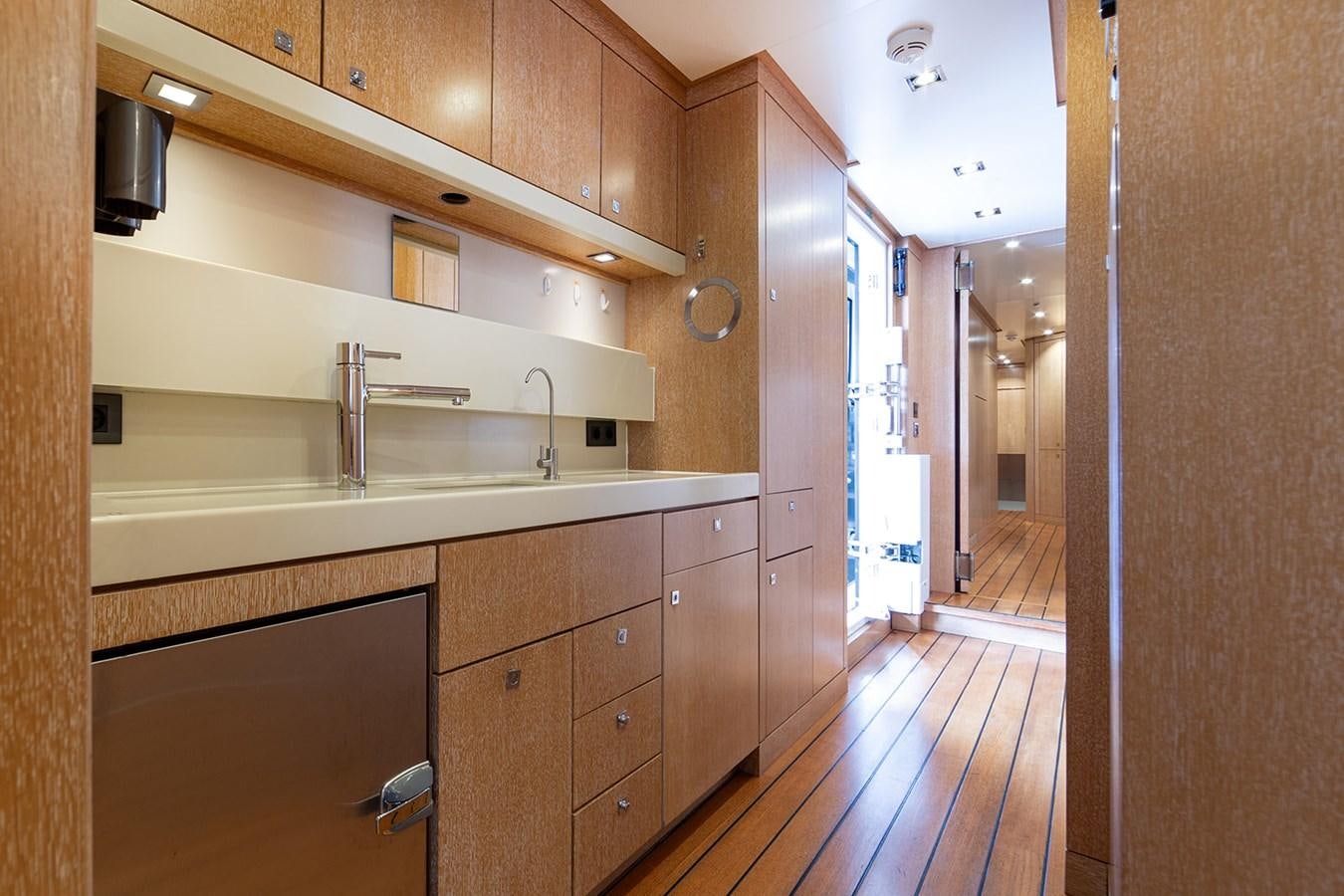 a kitchen with wooden cabinets aboard BELONGERS Yacht for Sale
