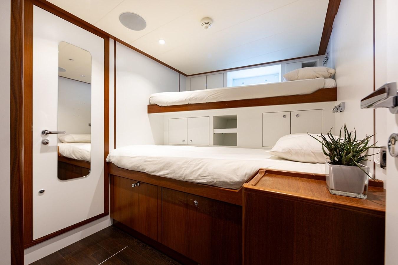 a bed with a white bed aboard BELONGERS Yacht for Sale