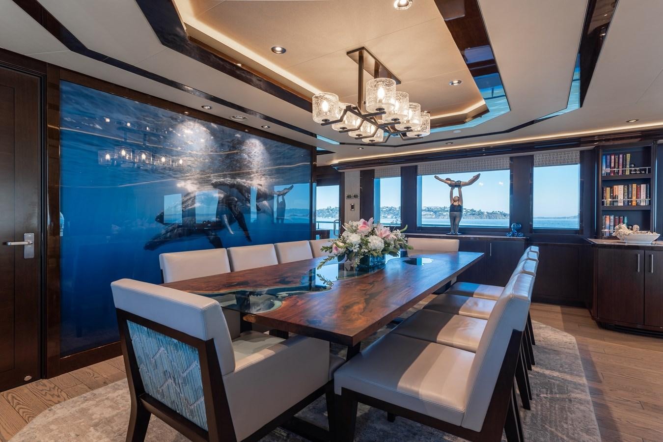 a room with a table chairs and a large window aboard FIGARO Yacht for Sale