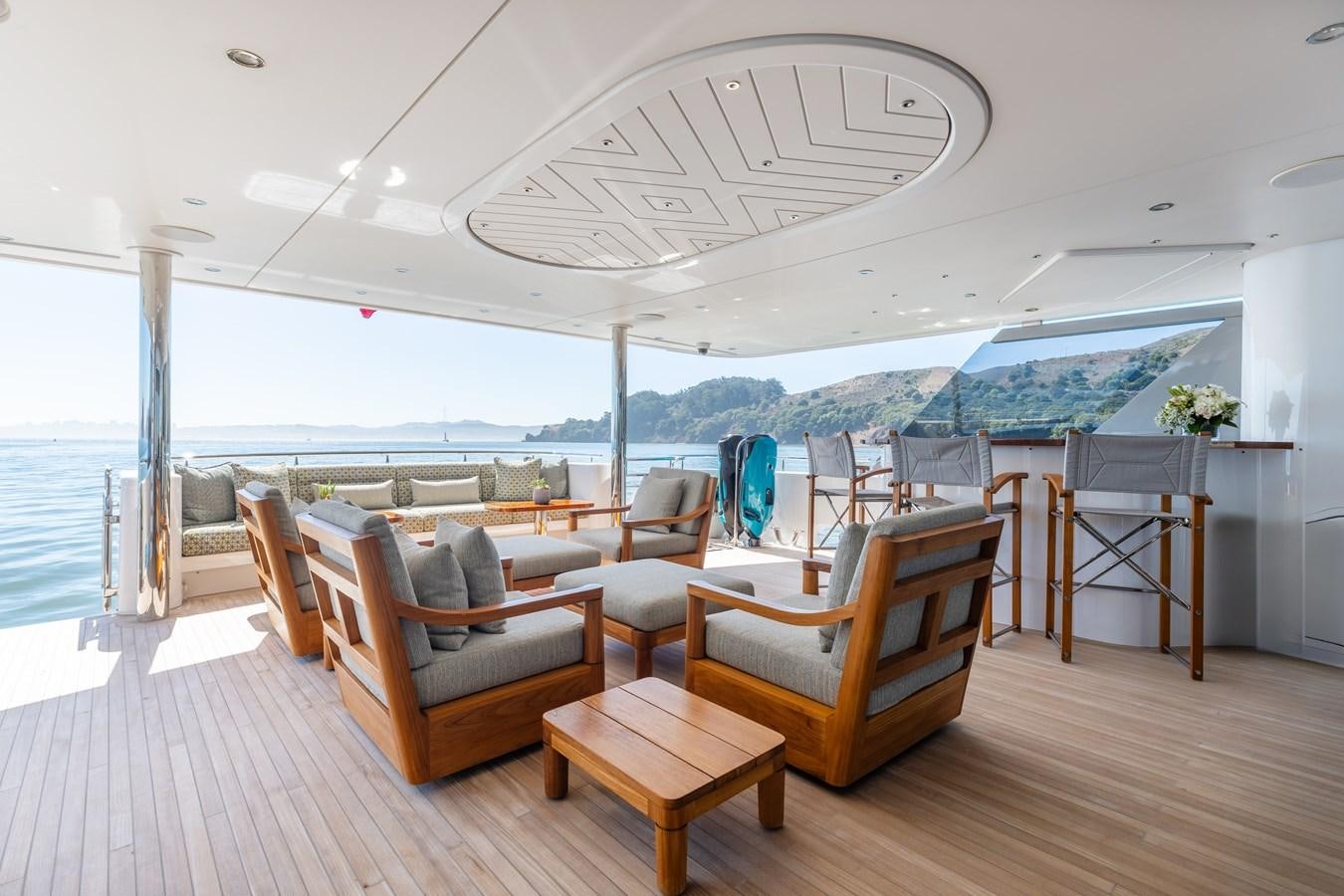 a room with a large table and chairs and a large glass ceiling aboard FIGARO Yacht for Sale