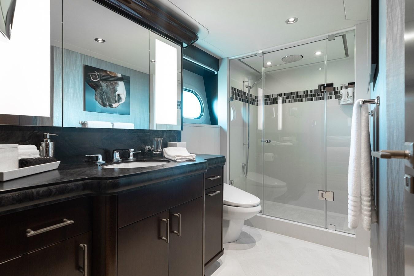 a bathroom with a glass shower aboard FIGARO Yacht for Sale