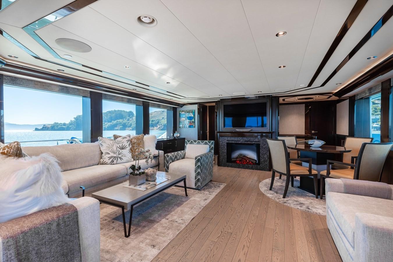 a living room with a fireplace aboard FIGARO Yacht for Sale