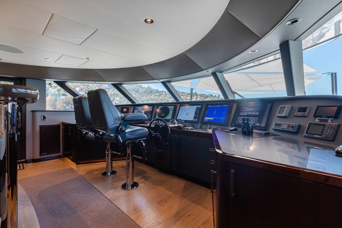 a room with a desk and chairs aboard FIGARO Yacht for Sale