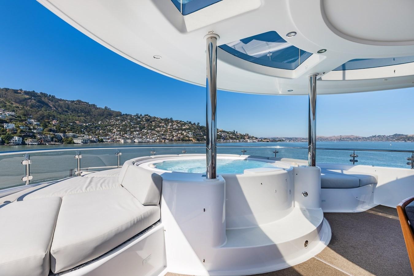 a white bathtub in a room with a view of a city aboard FIGARO Yacht for Sale