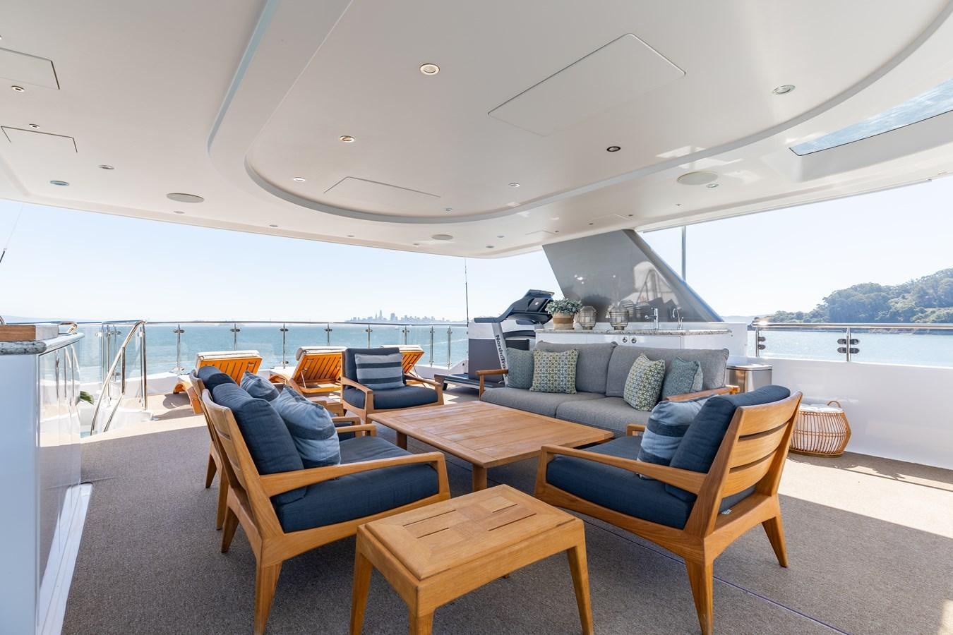 a room with a couch and a table and chairs aboard FIGARO Yacht for Sale