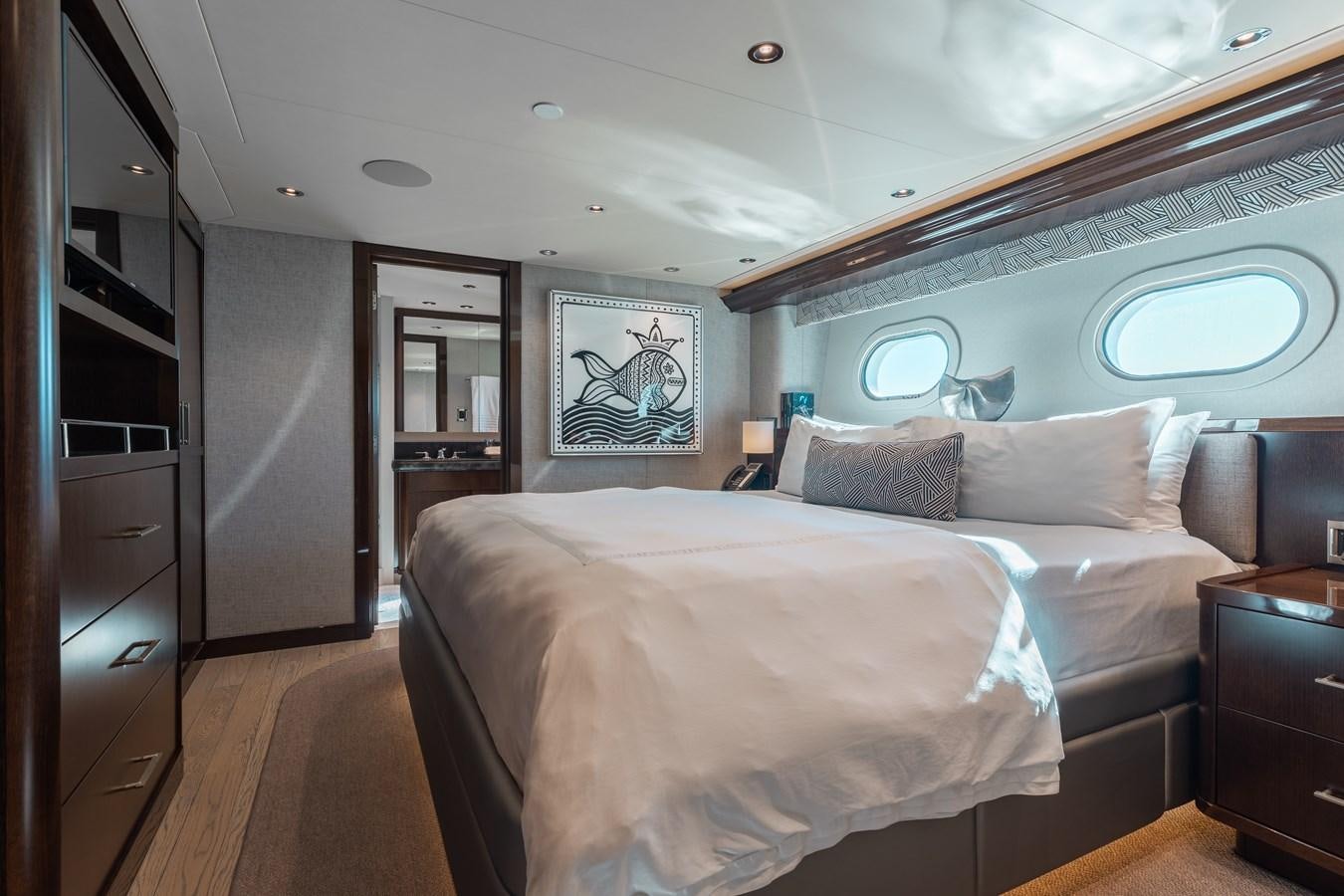 a bedroom with a bed and a window aboard FIGARO Yacht for Sale
