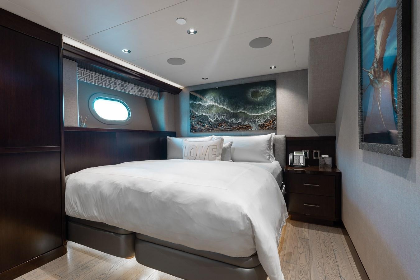 a bedroom with a bed and a television on the wall aboard FIGARO Yacht for Sale