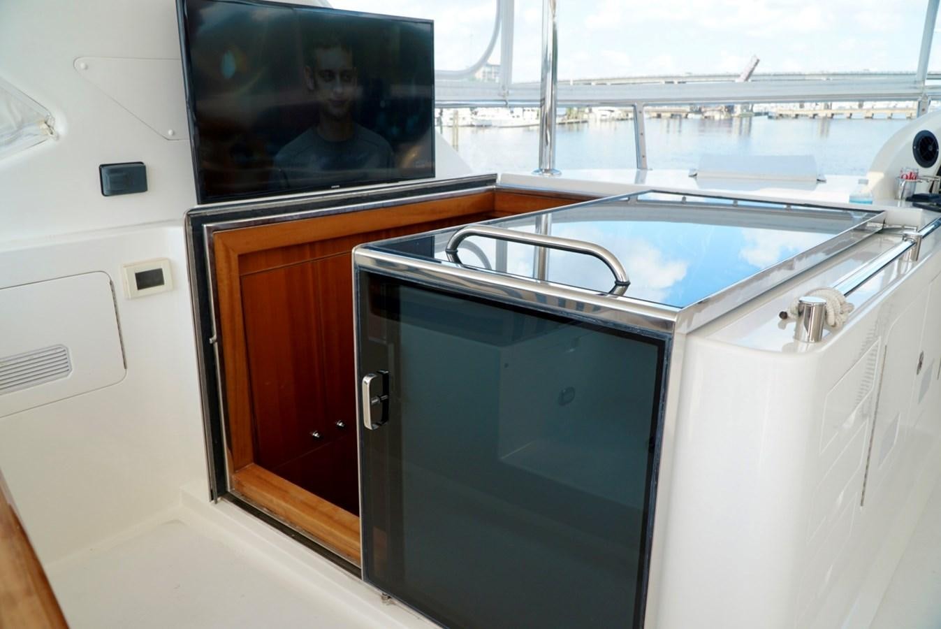 a sink and a refrigerator in a room aboard MISS PATTI Yacht for Sale
