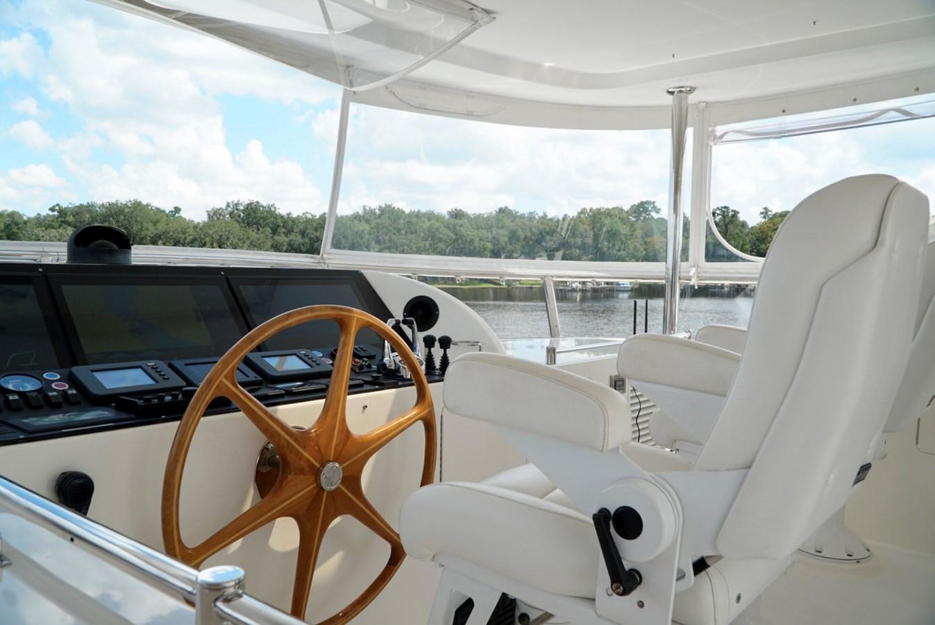 a boat with a steering wheel and seats on the front aboard MISS PATTI Yacht for Sale