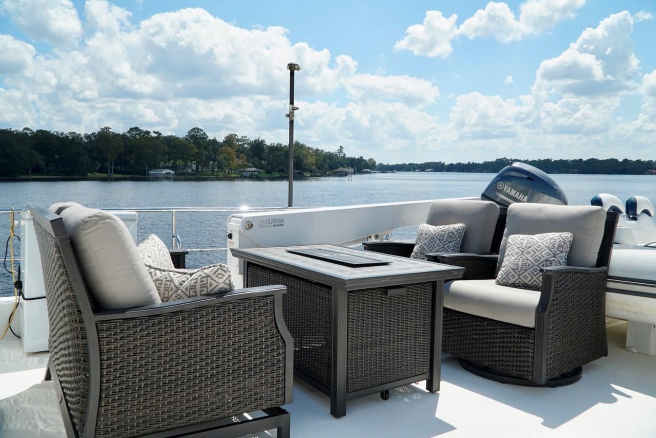 a patio with chairs and a table aboard MISS PATTI Yacht for Sale