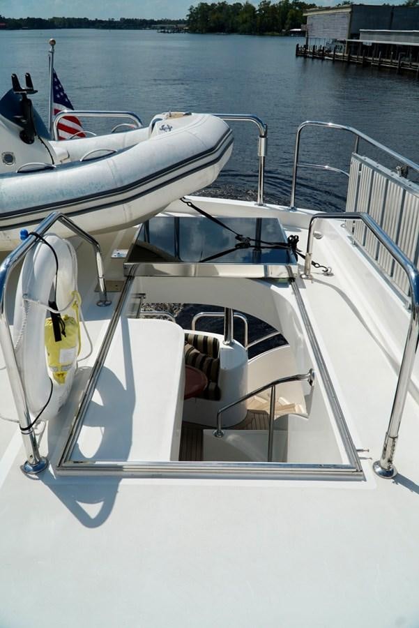 a boat with a flag on the front aboard MISS PATTI Yacht for Sale