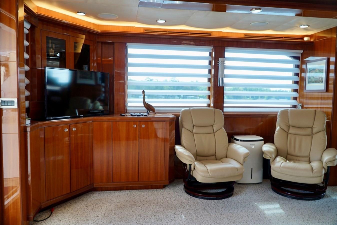 a room with a couple of chairs and a television aboard MISS PATTI Yacht for Sale