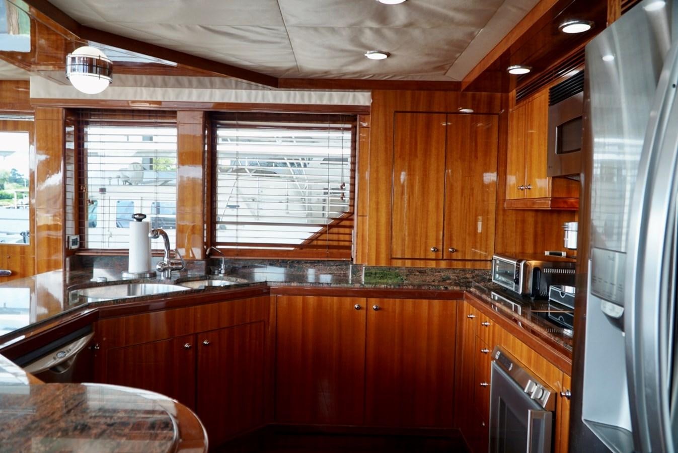 a kitchen with wooden cabinets aboard MISS PATTI Yacht for Sale