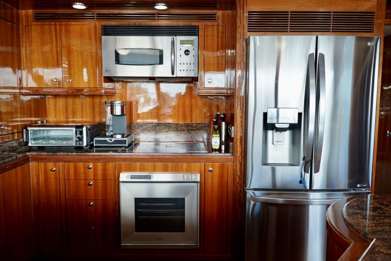a kitchen with wooden cabinets aboard MISS PATTI Yacht for Sale