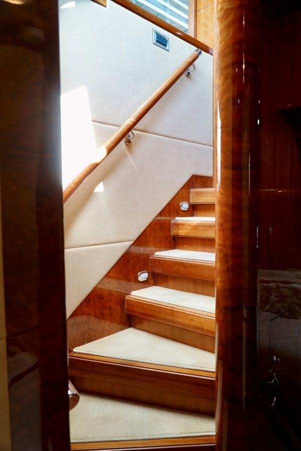 a wooden staircase with a white railing aboard MISS PATTI Yacht for Sale