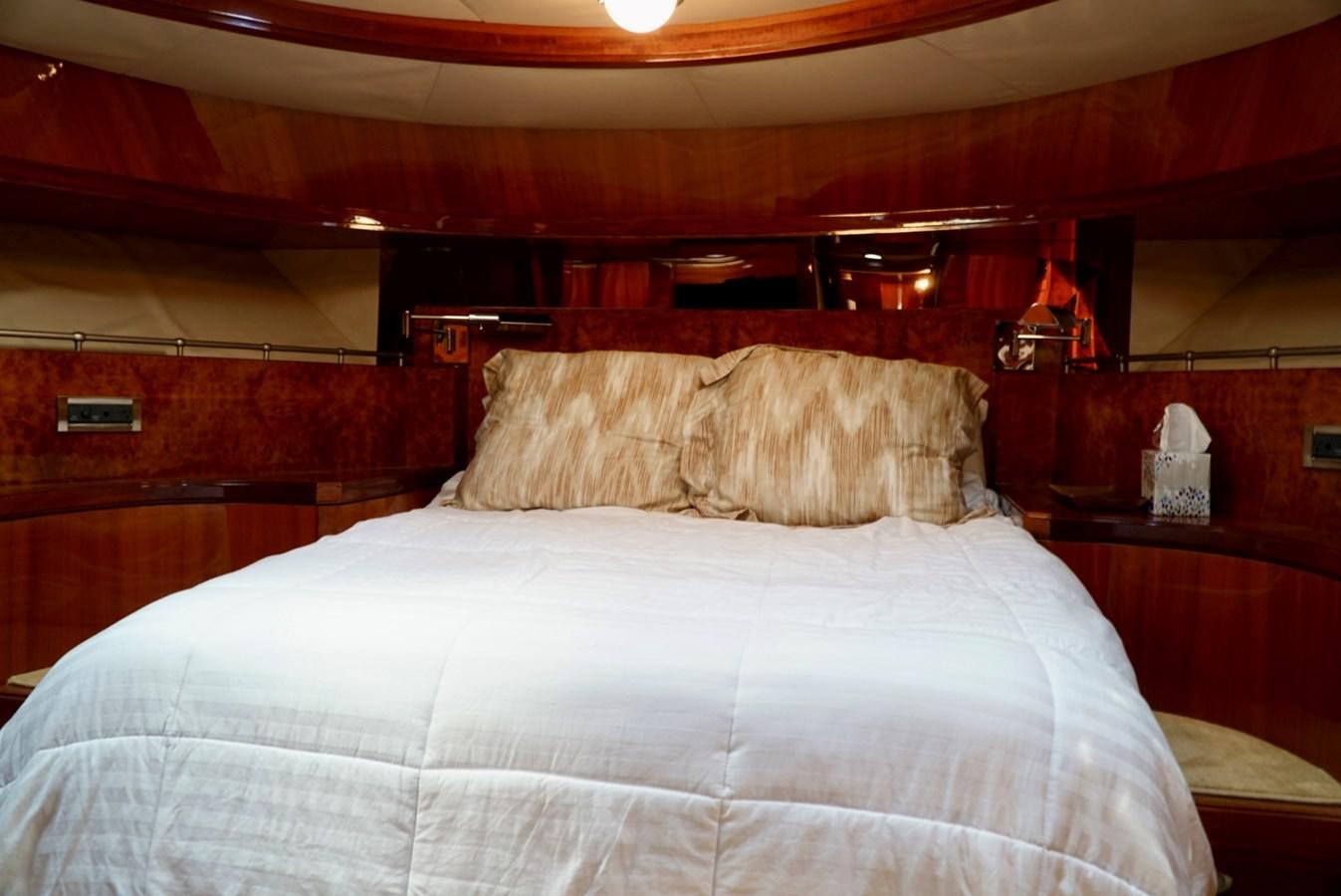 a bed with a white comforter aboard MISS PATTI Yacht for Sale