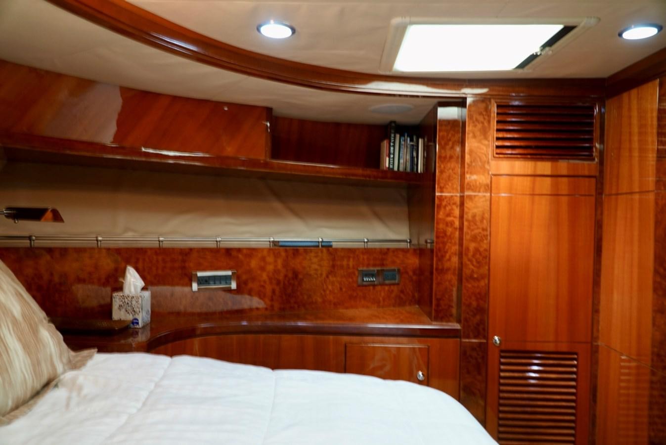 a room with a bed and a book shelf aboard MISS PATTI Yacht for Sale