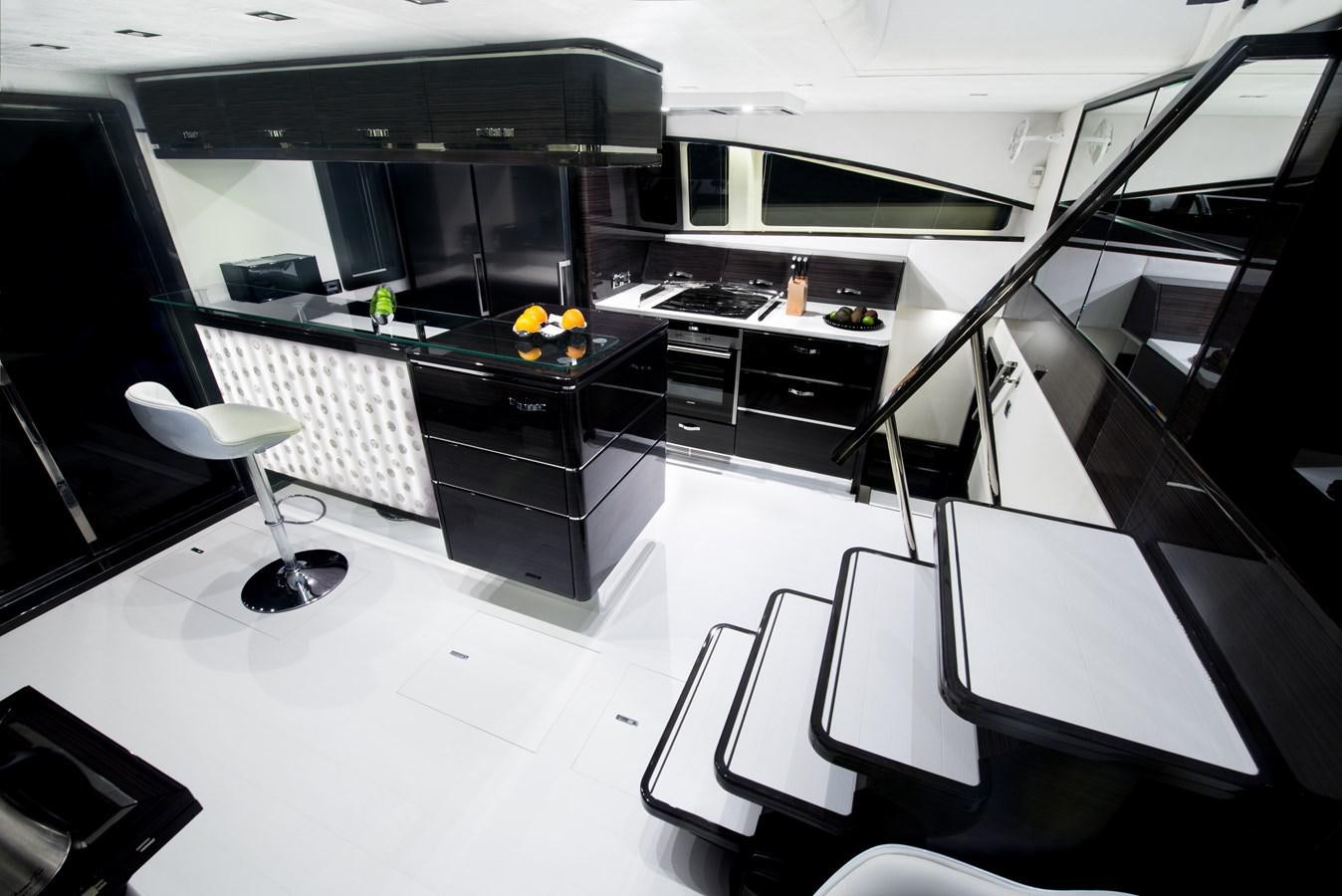 a room with a table and chairs aboard CLOUDS Yacht for Sale