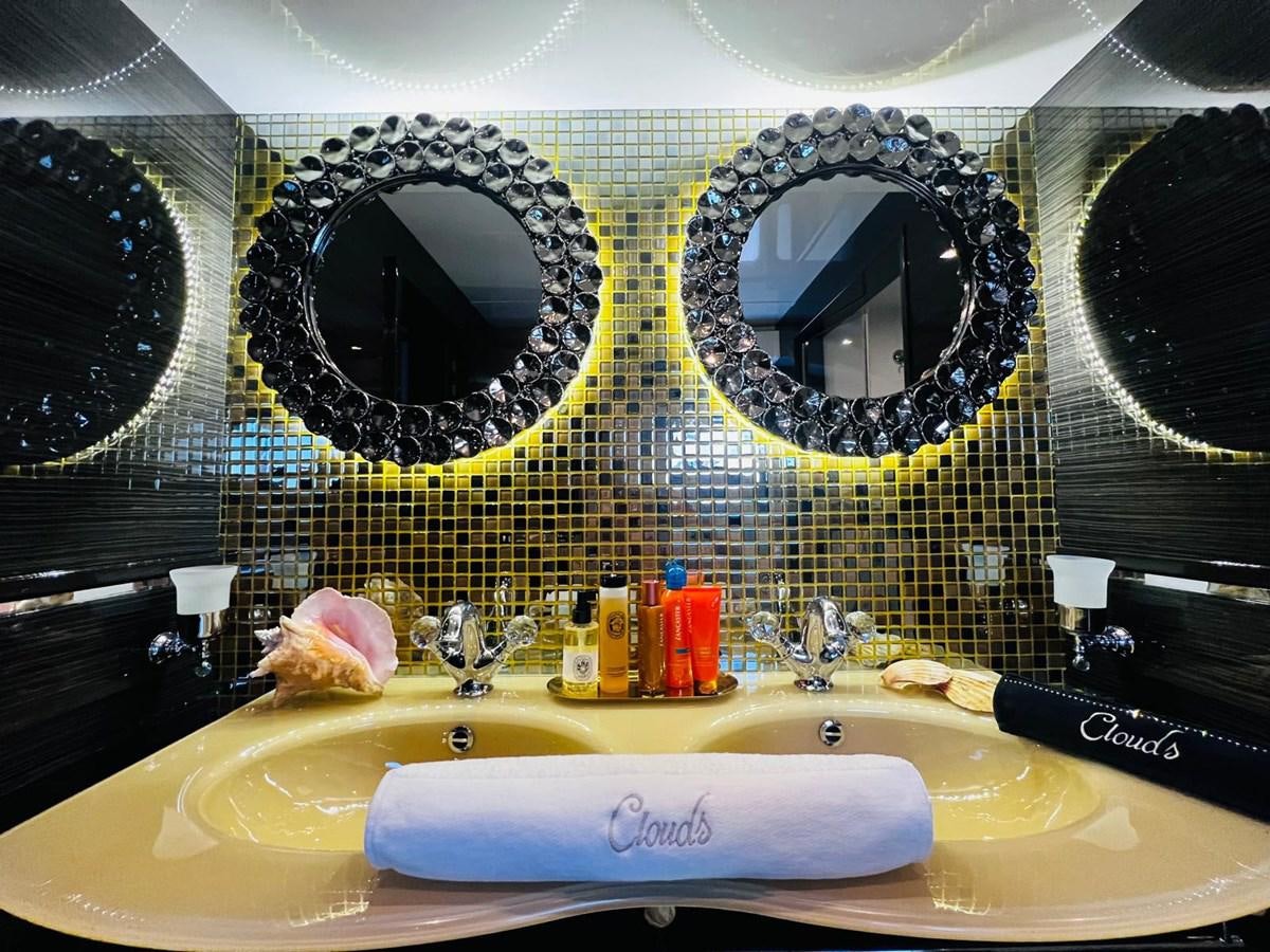 a bathroom with a large mirror aboard CLOUDS Yacht for Sale