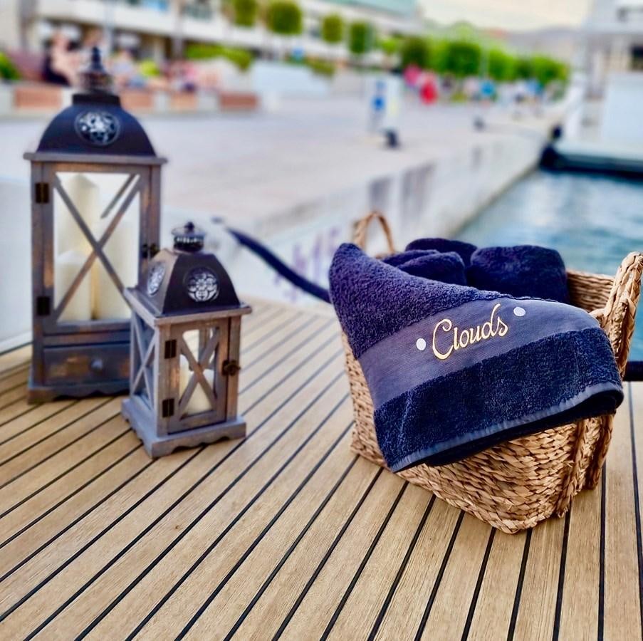 a hat and a couple of candles on a table aboard CLOUDS Yacht for Sale