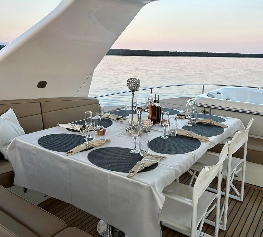 a table set for a dinner aboard CLOUDS Yacht for Sale