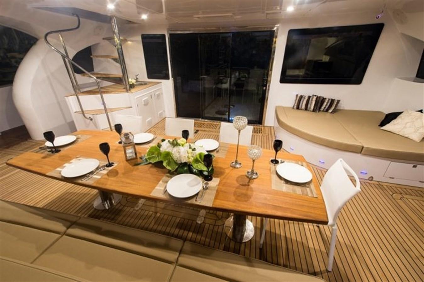 a table with plates and glasses aboard CLOUDS Yacht for Sale
