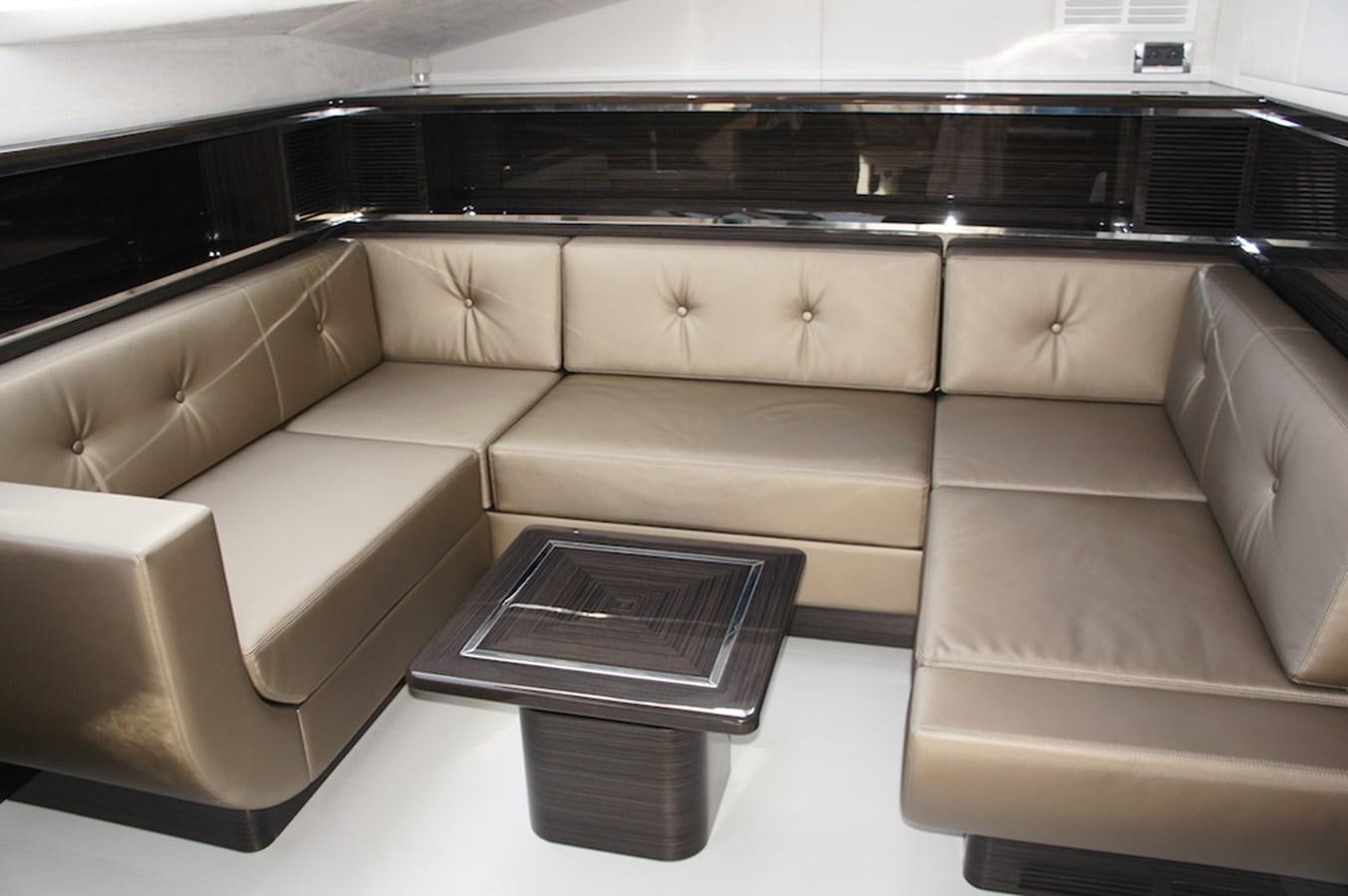 a room with a couch and a table aboard CLOUDS Yacht for Sale