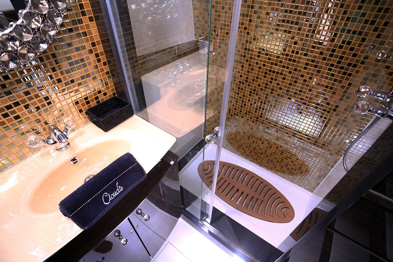 a bathroom with a glass shower aboard CLOUDS Yacht for Sale