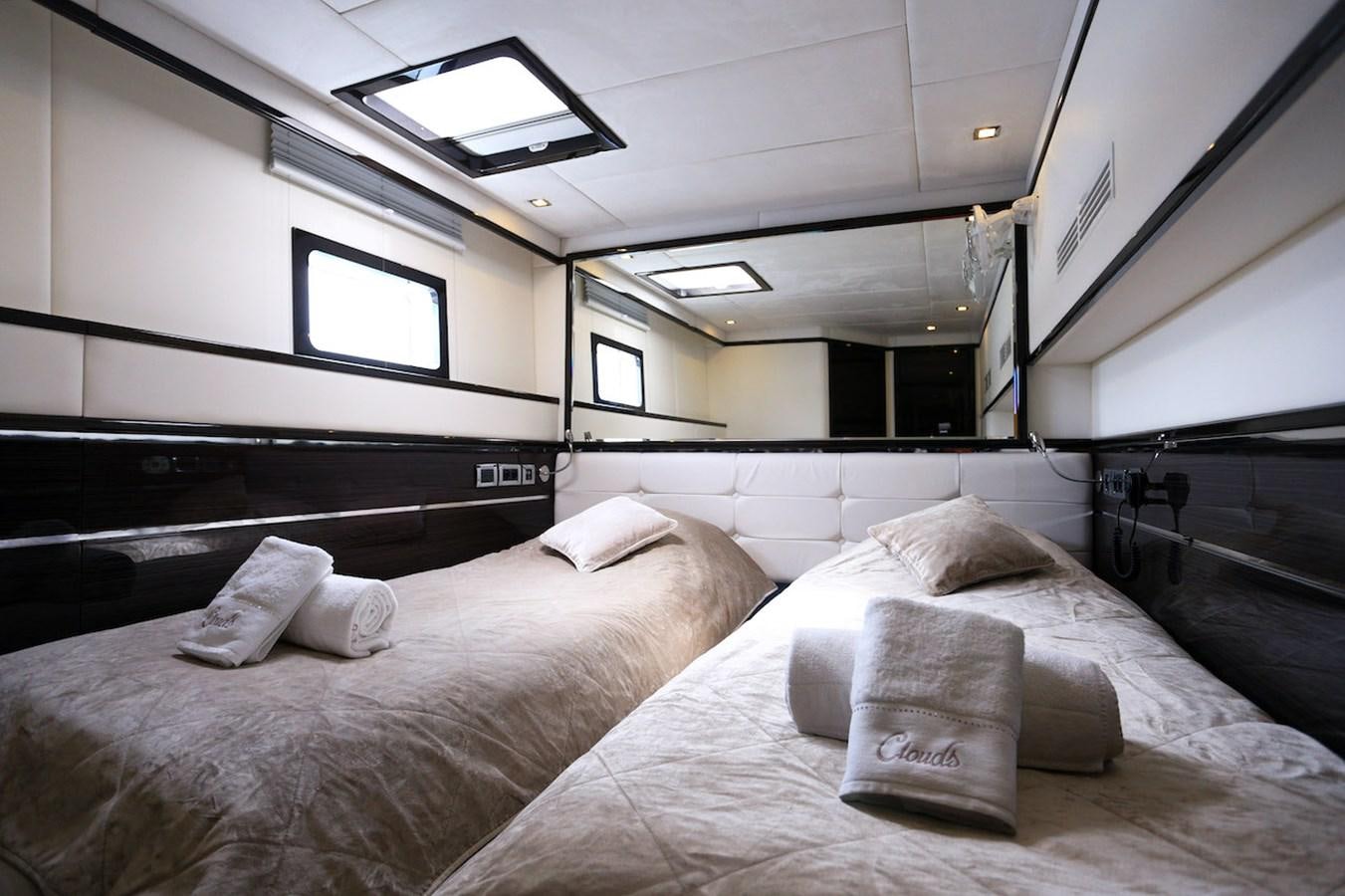 a room with a bed and a window aboard CLOUDS Yacht for Sale