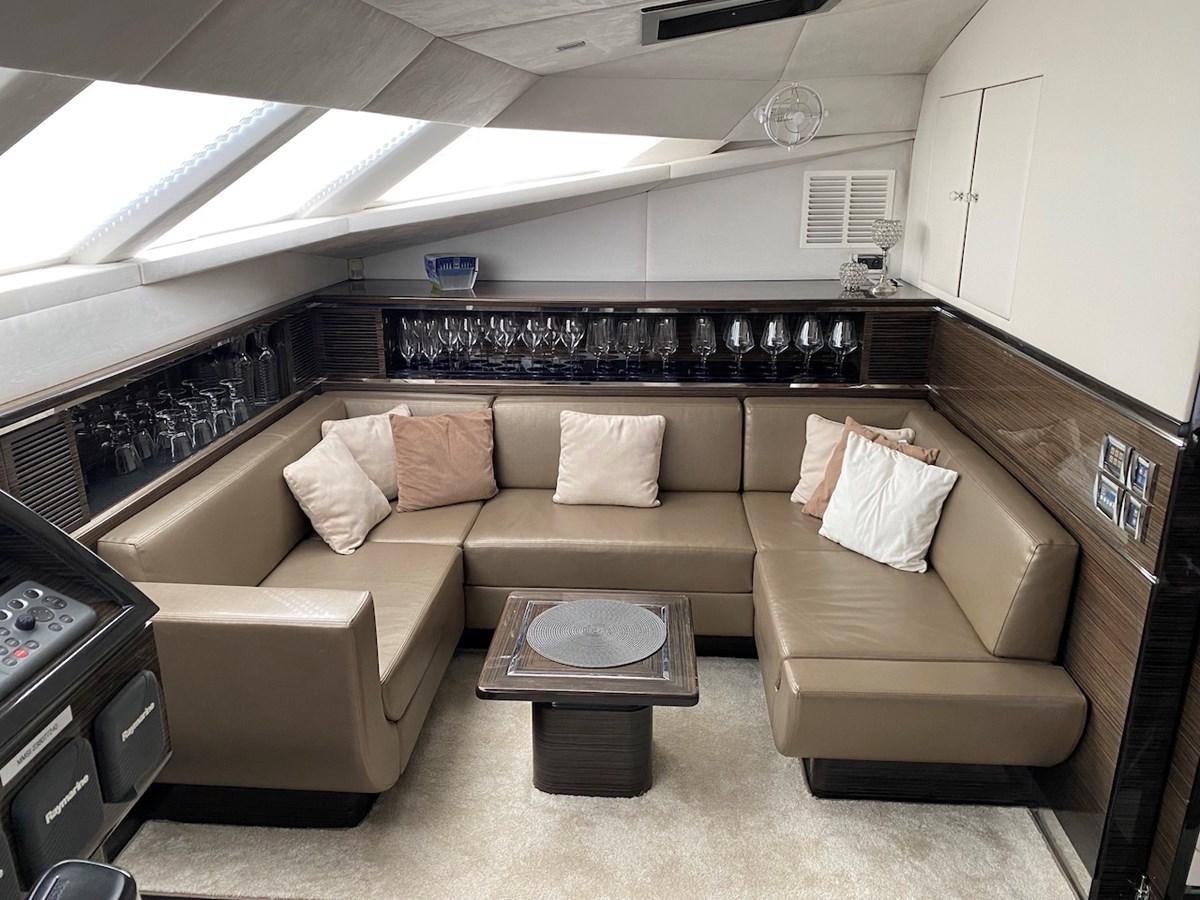 a brown leather couch in a room aboard CLOUDS Yacht for Sale