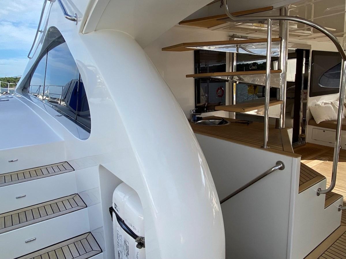 a white boat with a deck aboard CLOUDS Yacht for Sale