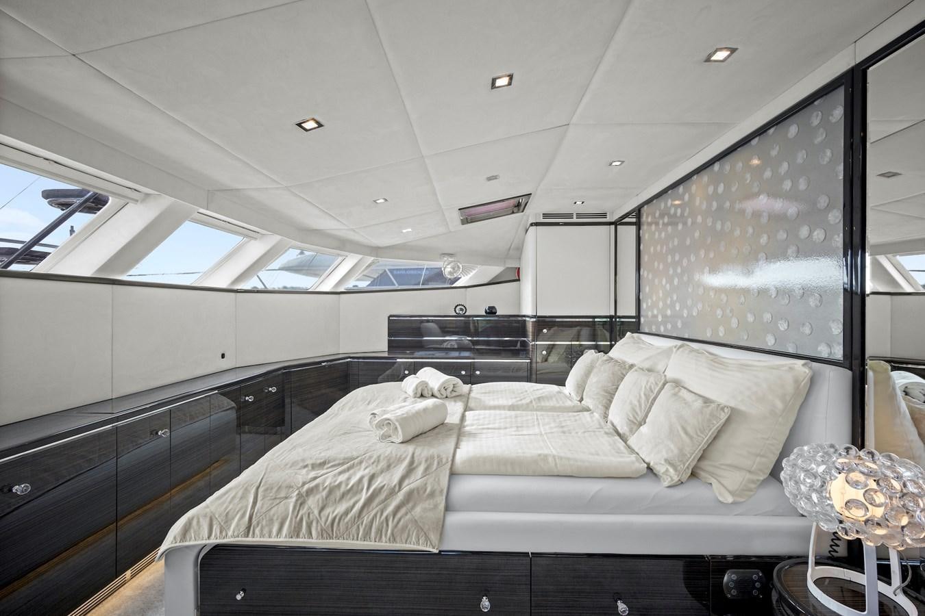 a room with a bed and a mirror aboard CLOUDS Yacht for Sale