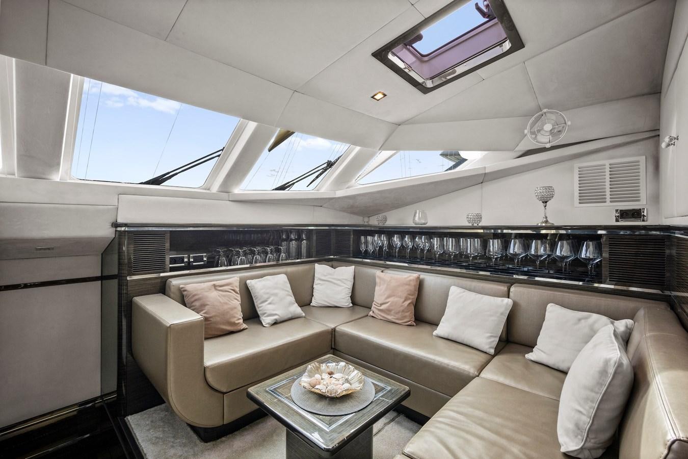 a room with a couch and a television aboard CLOUDS Yacht for Sale