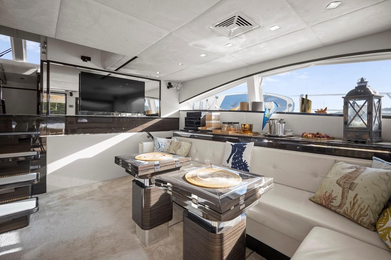 a room with a couch and a table aboard CLOUDS Yacht for Sale