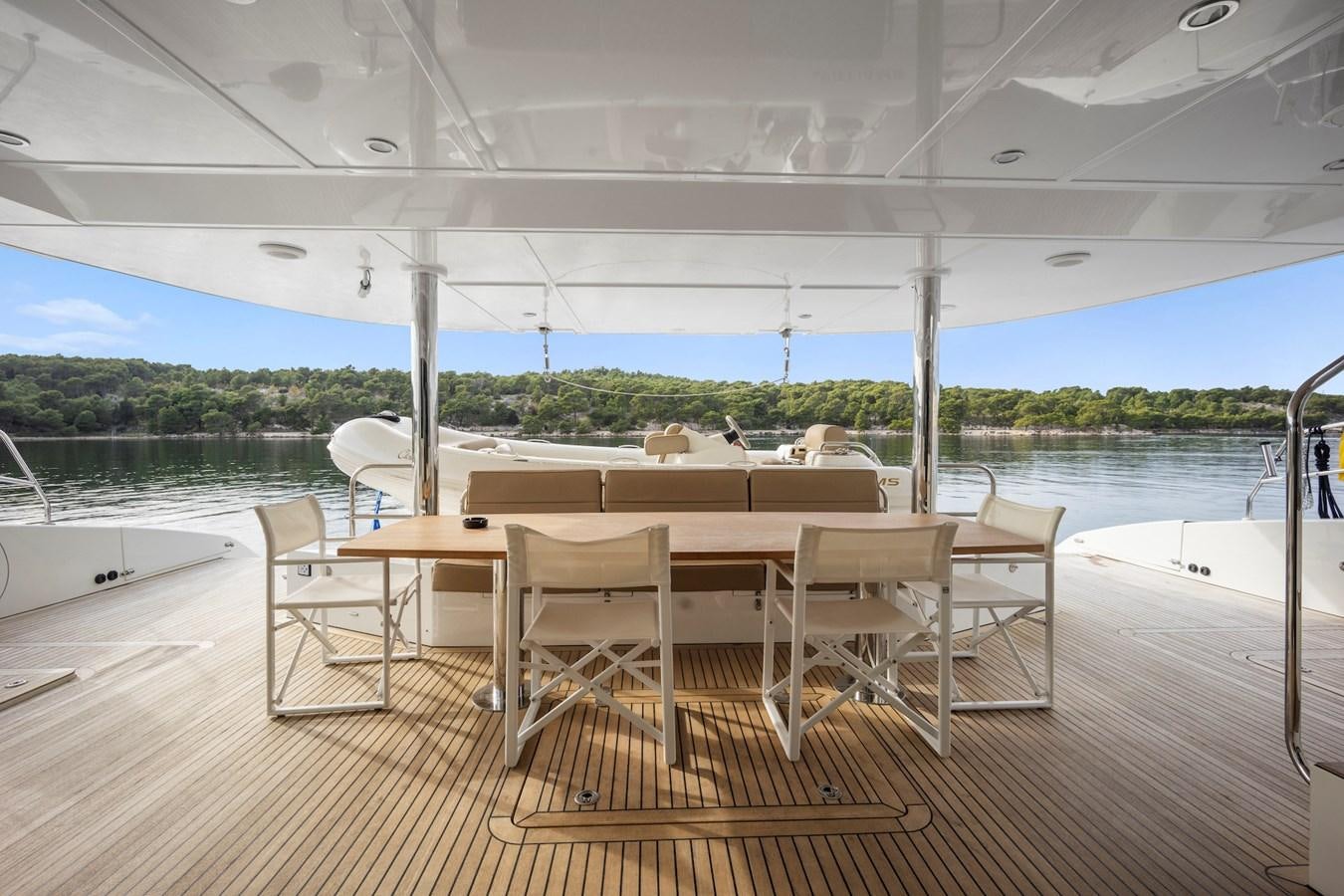 a table and chairs on a deck aboard CLOUDS Yacht for Sale