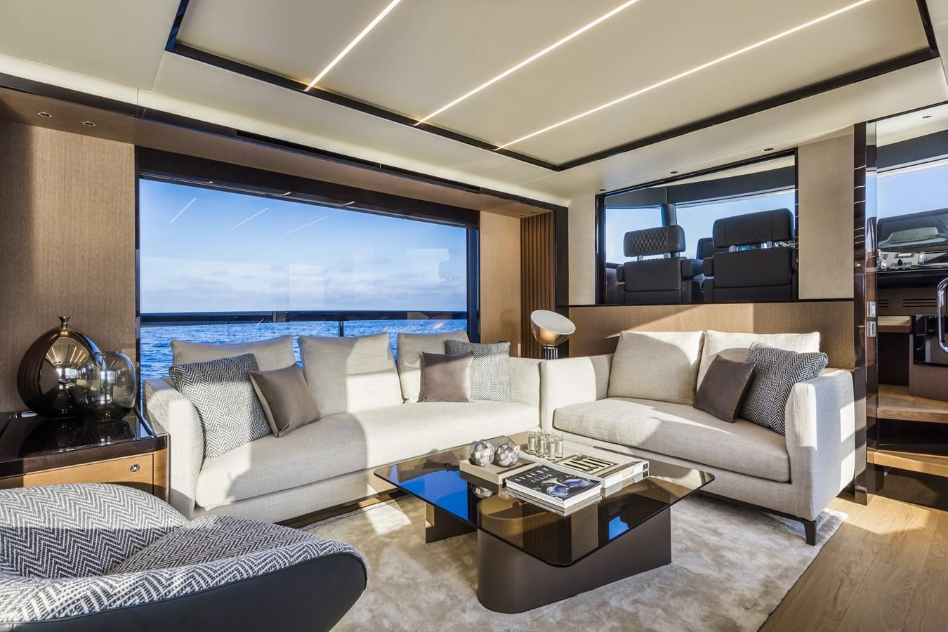 a living room with a large screen aboard 2025 ABSOLUTE NAVERTTA 68 Yacht for Sale