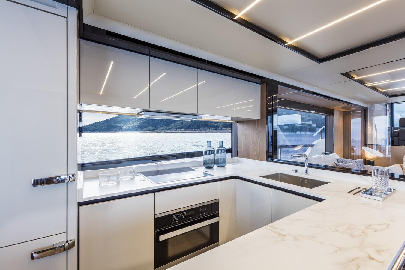 a kitchen with white cabinets aboard 2025 ABSOLUTE NAVERTTA 68 Yacht for Sale