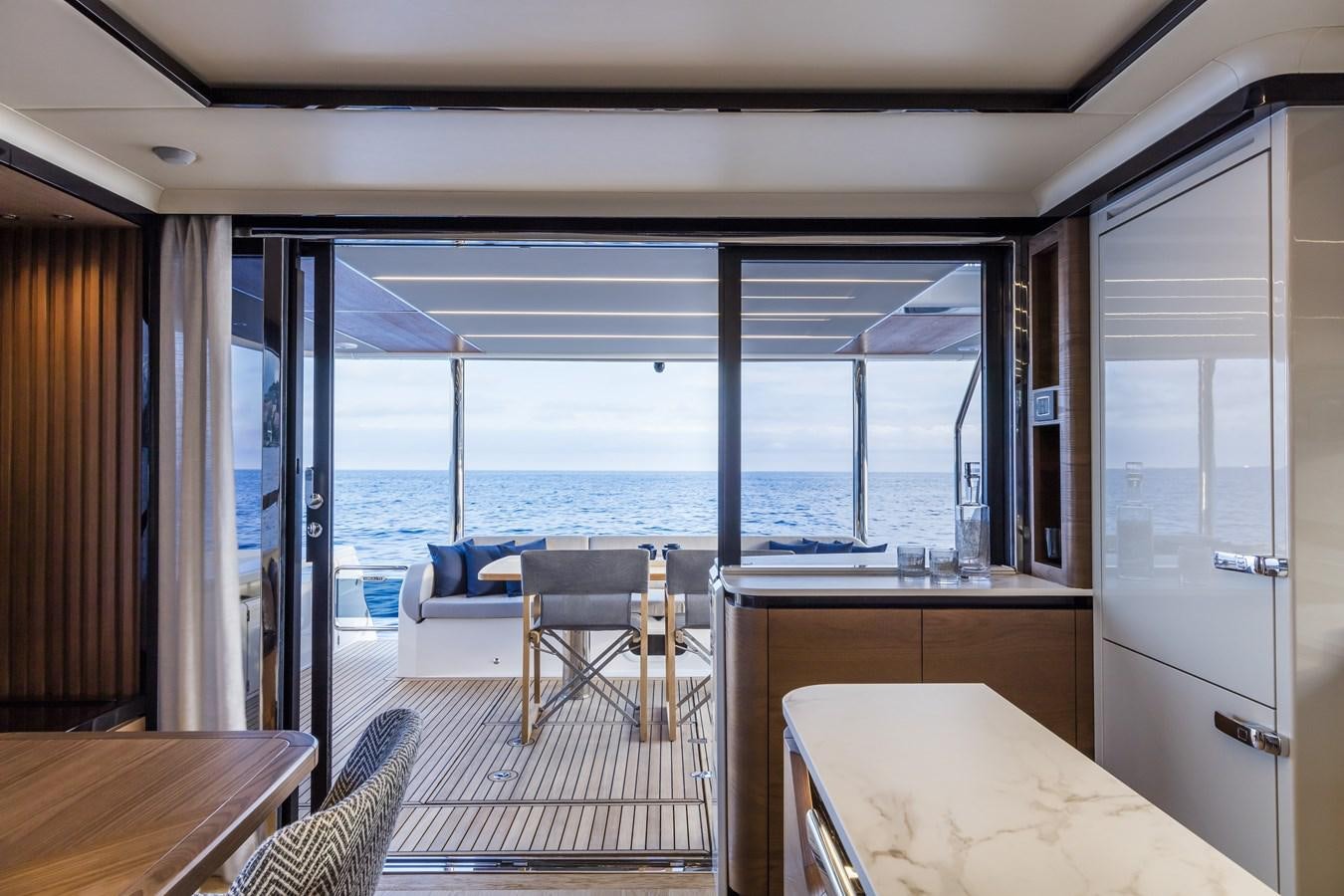 a room with a table and chairs aboard 2025 ABSOLUTE NAVERTTA 68 Yacht for Sale