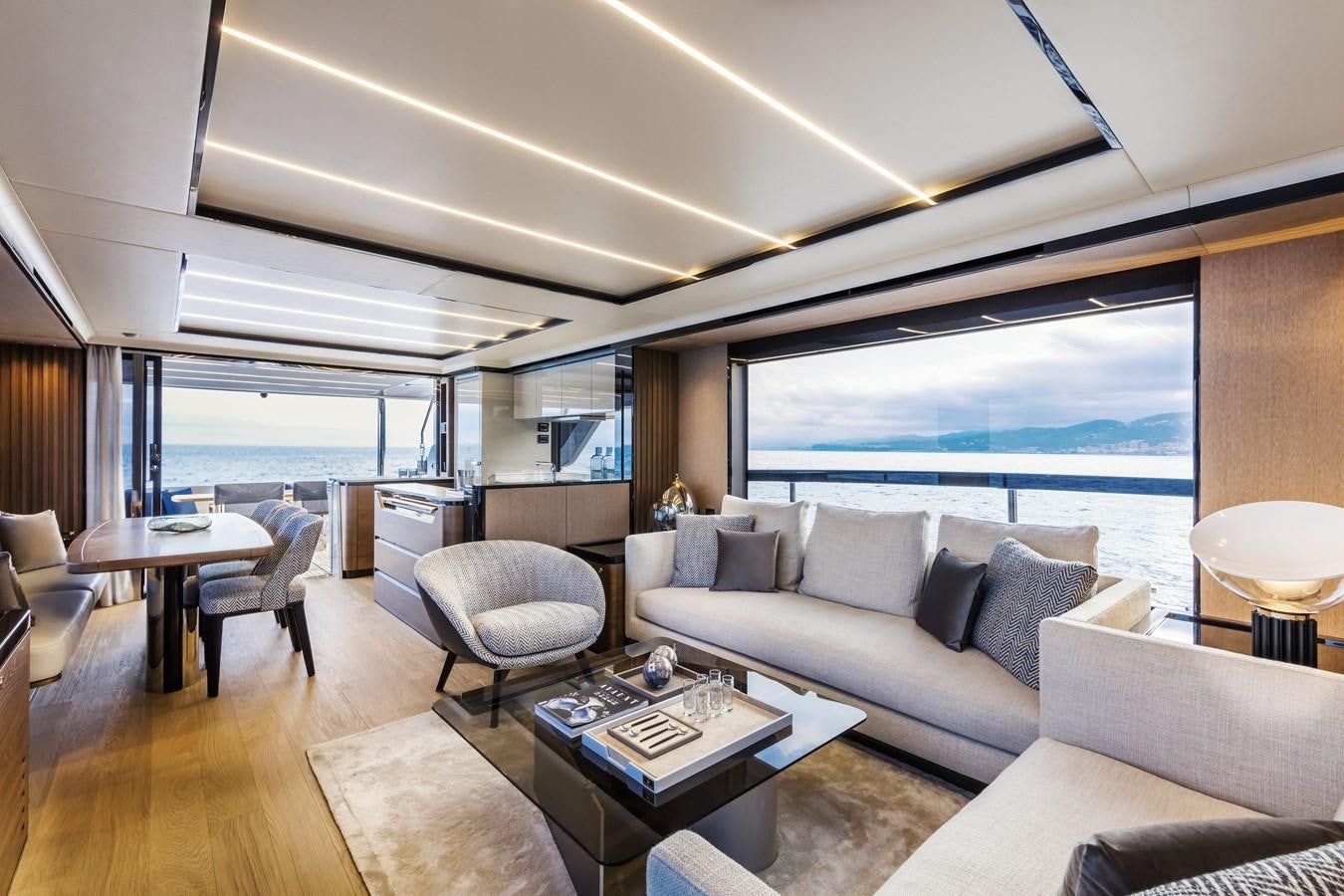 a living room with a large window aboard 2025 ABSOLUTE NAVERTTA 68 Yacht for Sale