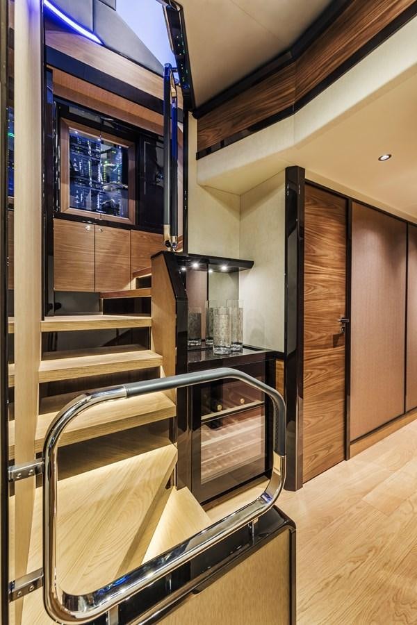 a kitchen with wooden cabinets aboard 2025 ABSOLUTE NAVERTTA 68 Yacht for Sale