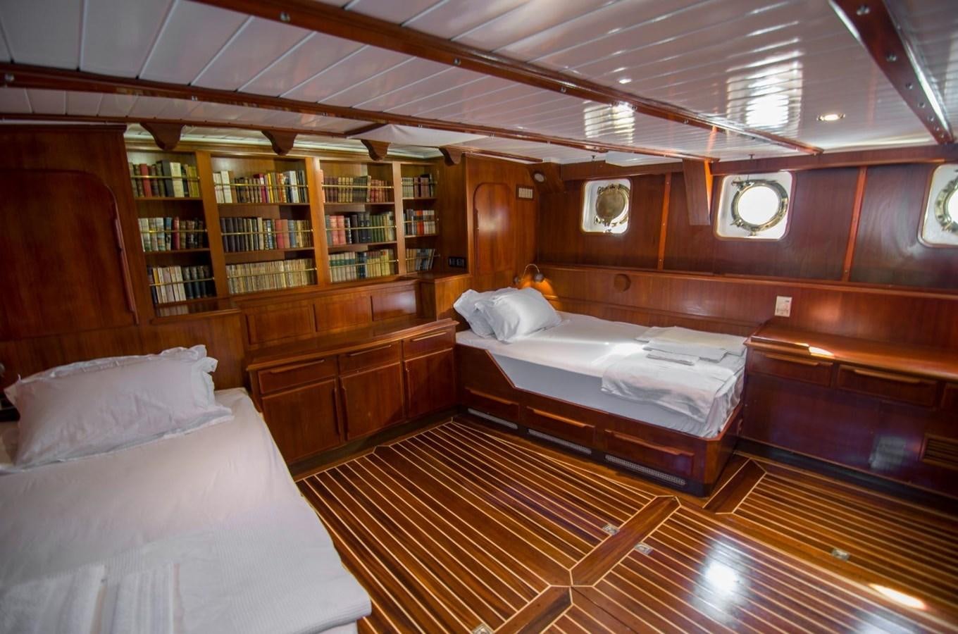 a room with wooden walls and a couple of beds aboard HARRY HALLER Yacht for Sale