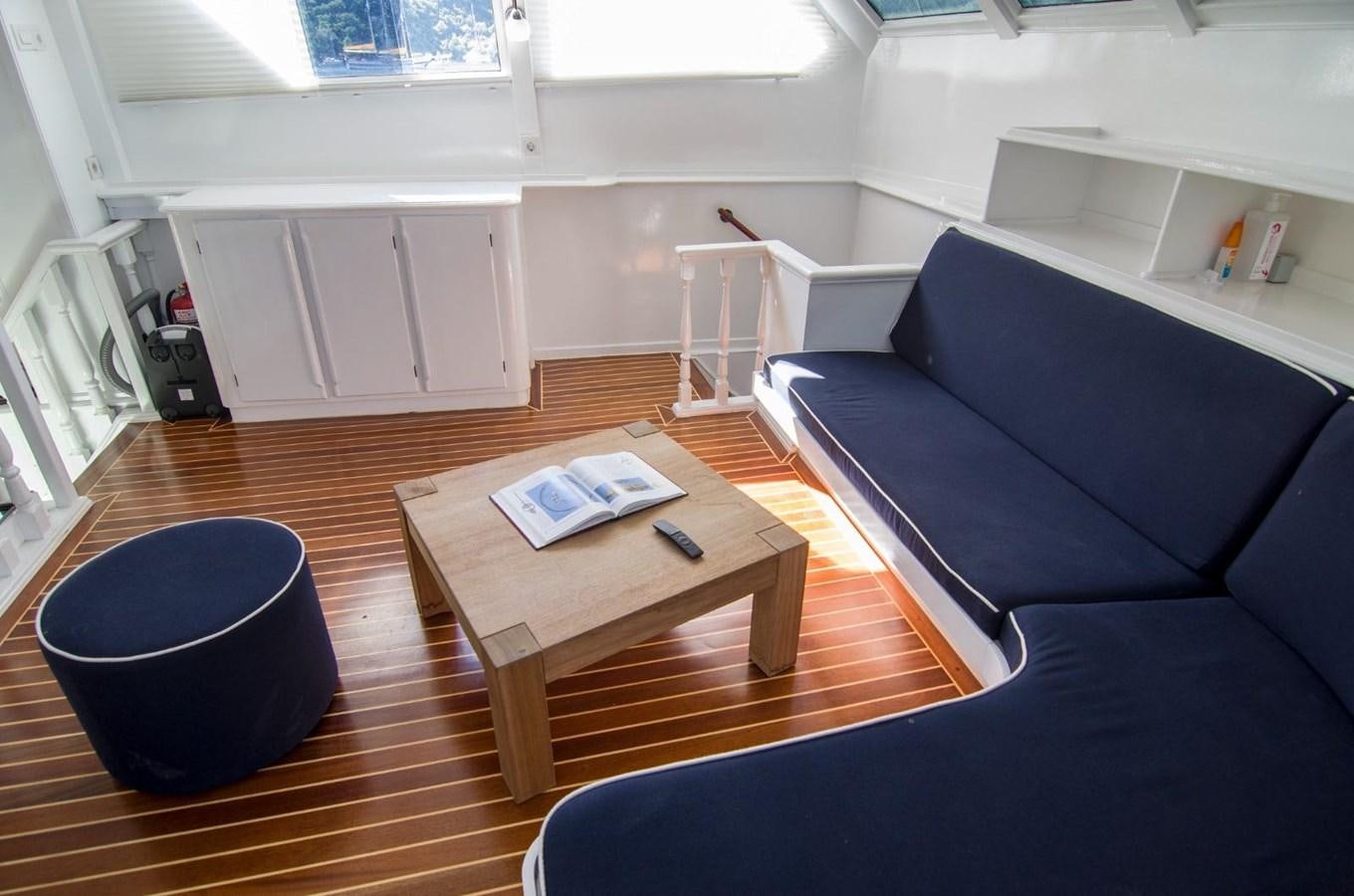 a living room with a couch and a coffee table aboard HARRY HALLER Yacht for Sale