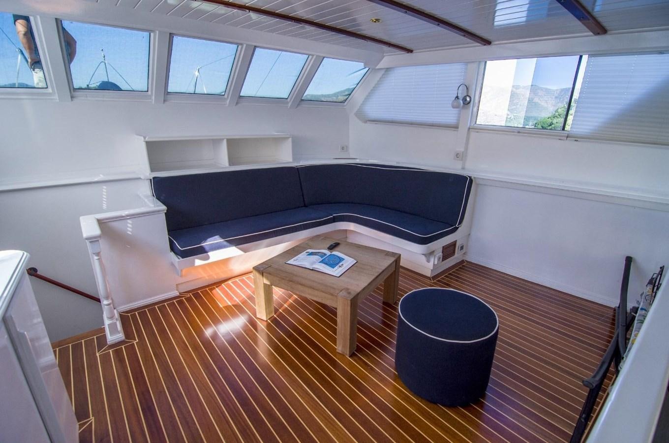 a couch and a table in a room aboard HARRY HALLER Yacht for Sale