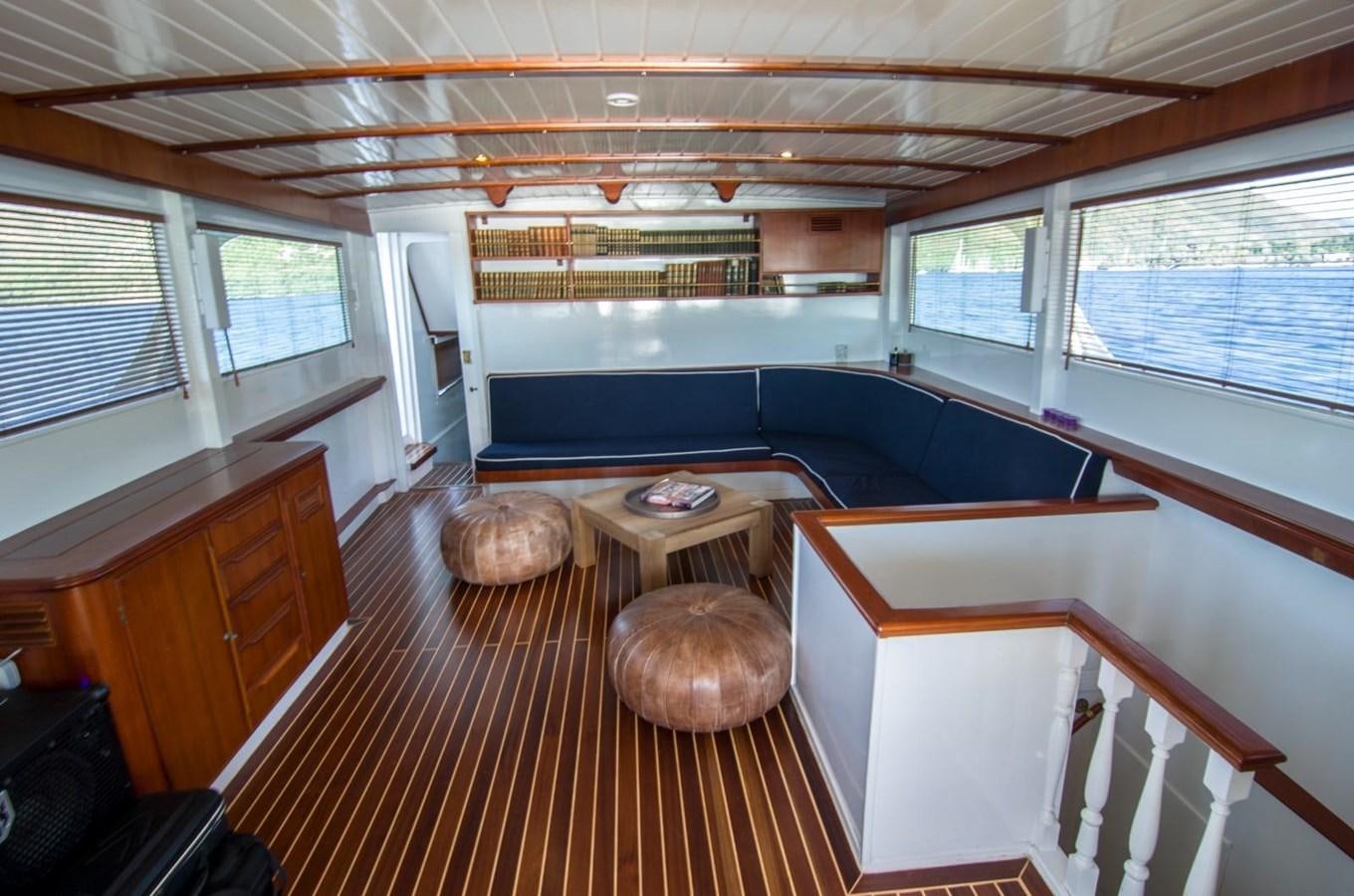 a room with a bed and a table aboard HARRY HALLER Yacht for Sale
