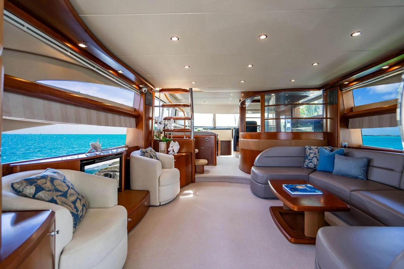 a living room with a large blue swimming pool aboard EMPIRE SUN Yacht for Sale