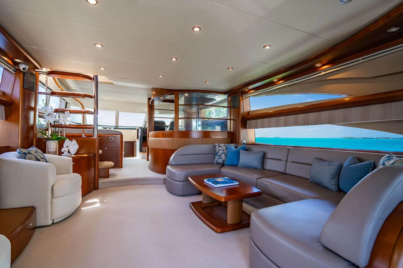 a living room with a large blue couch and a pool table aboard EMPIRE SUN Yacht for Sale