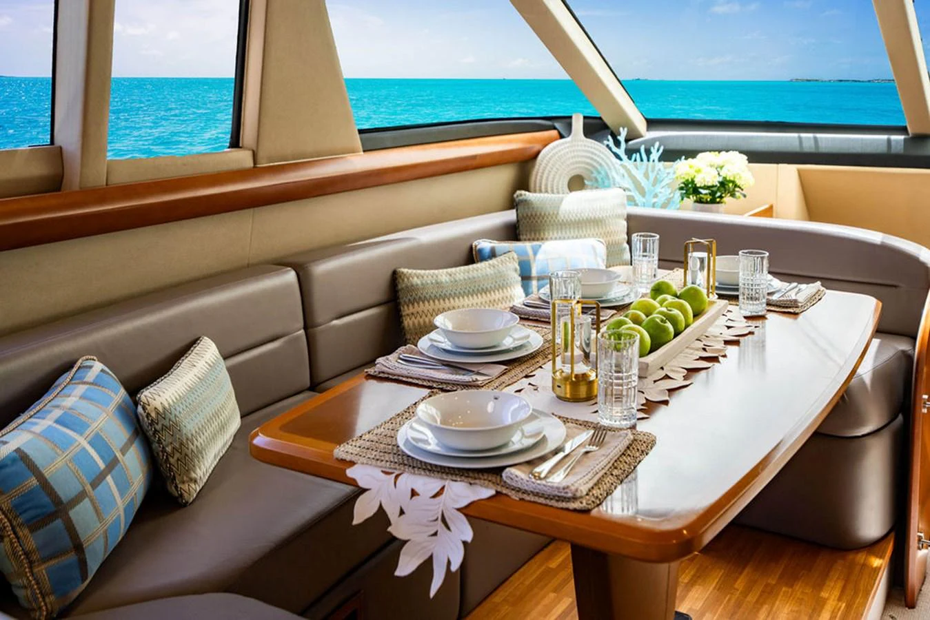a table with plates and glasses on it aboard EMPIRE SUN Yacht for Sale