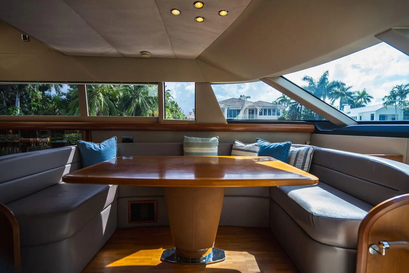 a table and couch in a room aboard EMPIRE SUN Yacht for Sale