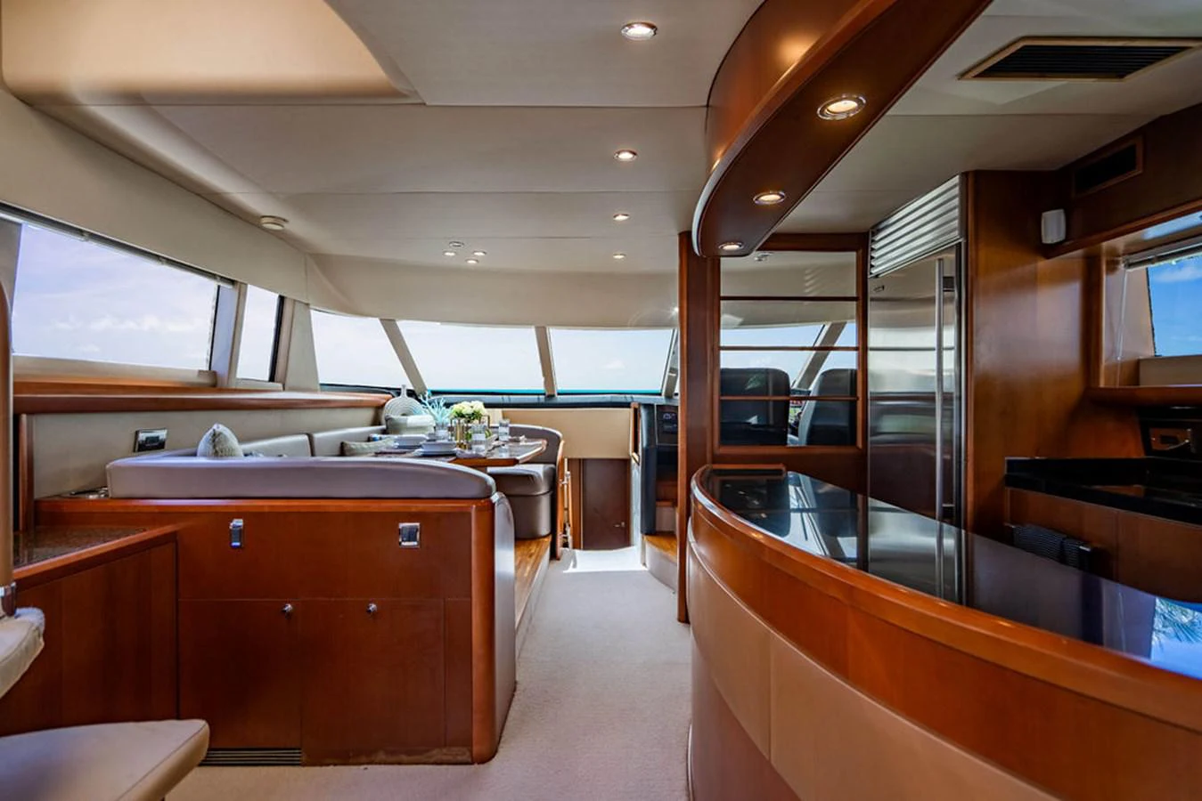 a room with a counter and chairs aboard EMPIRE SUN Yacht for Sale